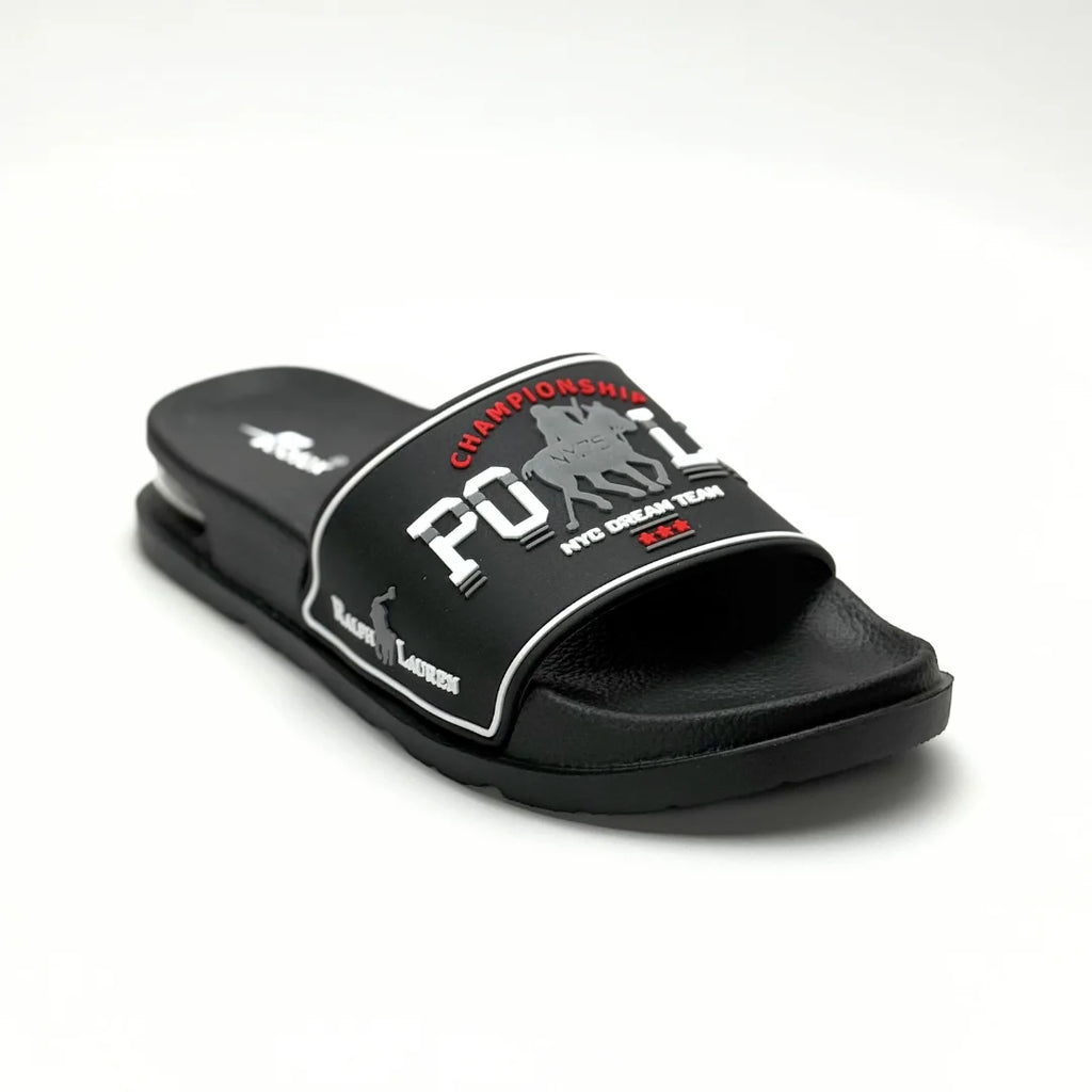 A black slide sandal with a wide strap featuring a white and red 'POLO CHAMPIONSHIP' graphic with polo player silhouettes, set against a plain white background.