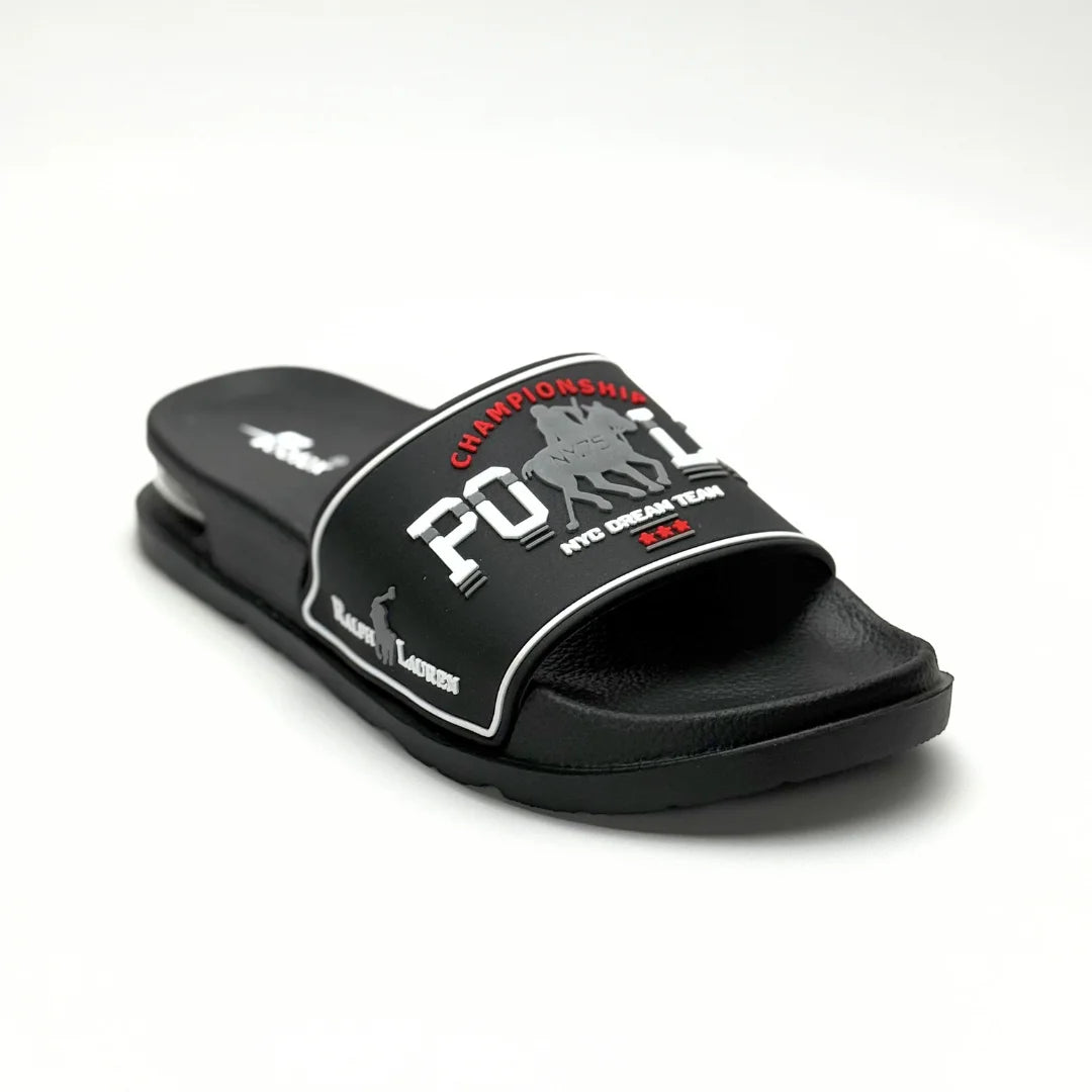 A black slide sandal with a wide strap featuring a white and red 'POLO CHAMPIONSHIP' graphic with polo player silhouettes, set against a plain white background.
